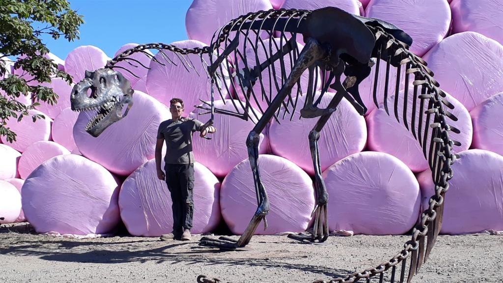 A FOSSIL-MAD teenager has stunned his teachers by creating a life-size dinosaur from scrap metal for an A-level project.  William Wisson-Burton, 17, spent eight months creating the 27-foot-long, 15ft high allosaurus in his dad’s workshop.  The giant model has taken 400 hours of work and was made using cast off metal and pieces of chain.