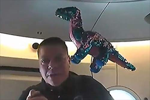 NASA astronaut Bob Behnken with "Tremor" the Apatosaurus on board SpaceX's Crew Dragon spacecraft in Earth orbit. (NASA TV)