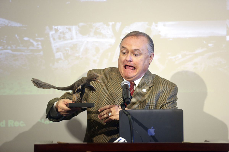 Mike Mower, Gov. Gary Herbert’s deputy chief of staff, makes a face while holding a statue of a Utahraptor during a press conference at the Capitol in Salt Lake City on Friday, Feb. 14, 2020, to discuss HB322, which would create Utahraptor State Park in the Dalton Wells area near Moab. Kristin Murphy, Deseret News